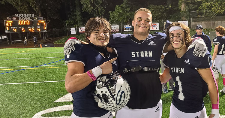 Jaydin Knapp, Ty Evans, and Teddy Beaver celebrate Skyview’s win over Union, with the Kiggins Bowl scoreboard in the background. Photo by Paul Valencia