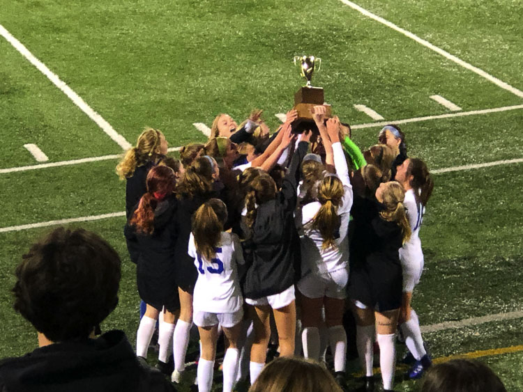 The Ridgefield Spudders hold up the Class 2A District 4 championship trophy last week after beating rival Hockinson. Ridgefield is the No. 3 seed for the state tournament. Photo courtesy Paytn Barnette