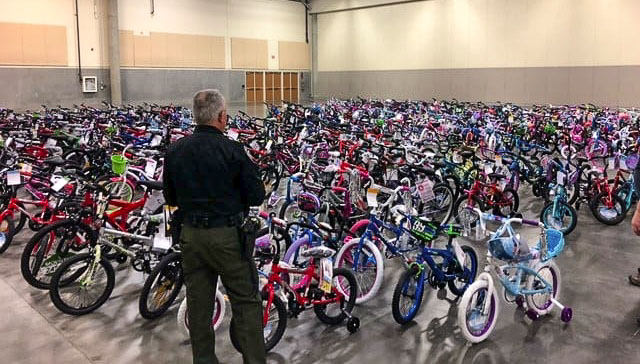 Sheriff Chuck Atkins gazes over bikes purchased and assembled for Santa’s Posse volunteers to distribute to area children. Photo courtesy Clark County Fire District 6
