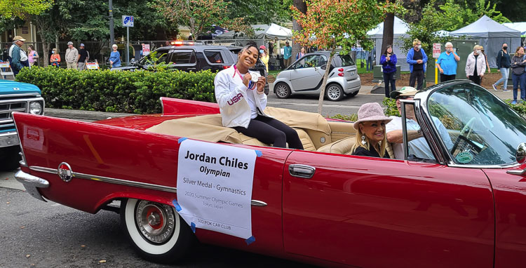 Jordan Chiles holds up her silver medal during a parade in her honor in Vancouver in August. Photo by Paul Valencia