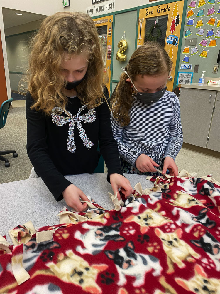 Cape Horn-Skye first graders Quinn Henry and Naomi Vest participate in the annual holiday-inspired lesson on gift giving. Photo courtesy Washougal School District