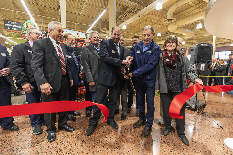 Ridgefield Mayor Don Stose (second from right) helps cut the ceremonial ribbon at the Grand Opening ceremony for the Rosauers in Ridgefield on Dec. 7, 2019. File photo