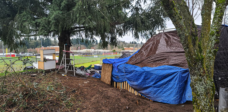 This tent is right next to the fence on Fort Vancouver High School’s campus. Spring sports athletes train and compete just on the other side of the fence. Photo by Paul Valencia