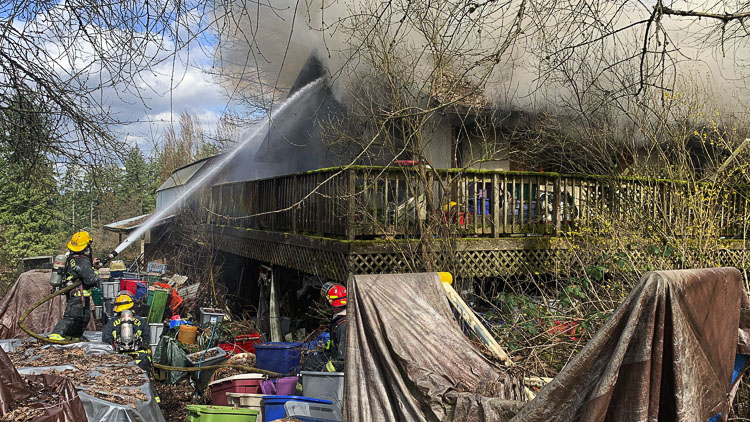 Clutter and a deck in disrepair blocked firefighters from entering the residence. Photo courtesy Clark-Cowlitz Fire Rescue