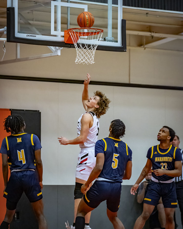 Evan Eschels has big hair and big numbers for the Union Titans. He is scoring in double figures and pulls down seven rebounds a game in his first year as a starter. Photo by Heather Tianen