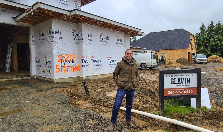 Niall Glavin of Glavin Homes stands in front of the two homes his company is building for this year’s GRO Parade of Homes, presented by HomeStreet Bank. The event, in Ridgefield this year, will be open in September. Photo by Paul Valencia