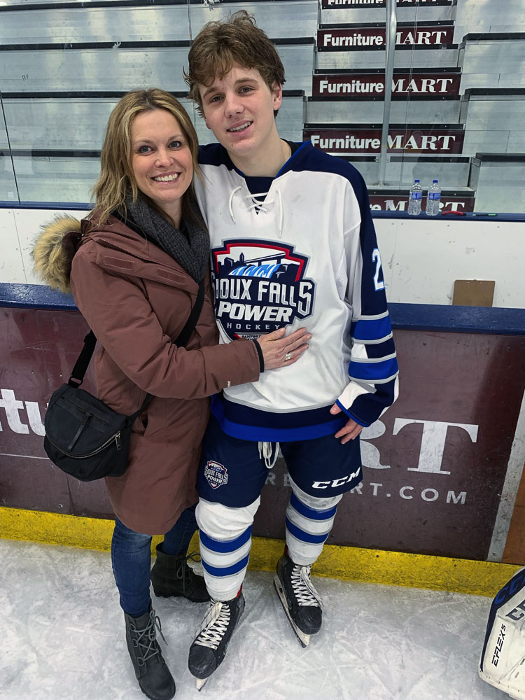 Rylan Oster and his mom Robyn share a moment on ice after a recent Sioux Falls Power game. Parents Robyn and Rory Oster have been going back-and-forth, leading two households: One in Camas and one in Minnesota, giving Rylan the opportunity to play and train for hockey year round. Photo courtesy Oster family