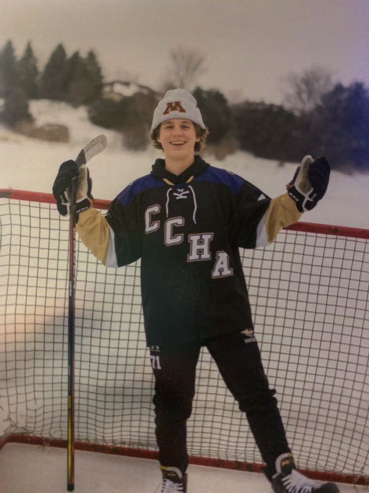 Rylan Oster, shown here as a freshman, enjoys the opportunity to play hockey outside, with snow in the background as well. A former Camas School District student, Oster moved to Minnesota in order to thrive in a hockey-rich environment. Photo courtesy Oster family