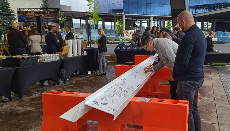 Guests were invited to sign the final beam that will be lifted up to the top of the hotel tower. Photo by Paul Valencia