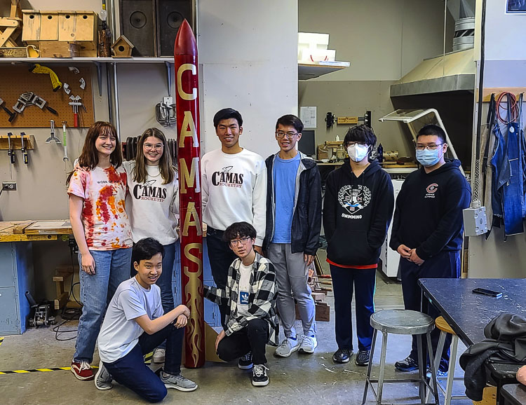 Some of the members of the Camas Rocketry Club at Camas High School pose with the club’s large rocket that was used for NASA’s Student Launch Initiative. Photo by Paul Valencia