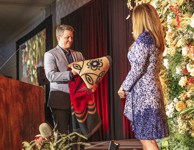 President Matt Morton gifts his predecessor, Jennifer Rhoads, an Eighth Generation blanket to recognize the significance of her leadership to the Community Foundation for Southwest Washington. Photo courtesy of Tom Cook Photography