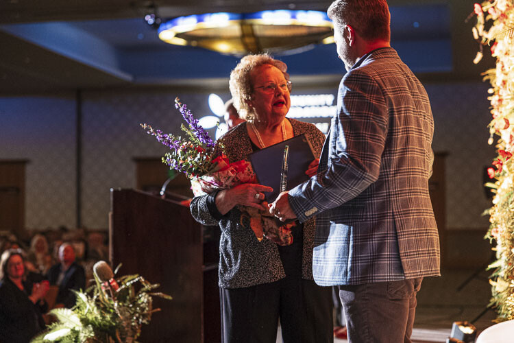 Geri Hiller (left) speaks with her friend Kevin Hiebert, owner of Resonate Consulting, after accepting the 2022 Community Champion Award from the Community Foundation for Southwest Washington. Photo courtesy of Tom Cook Photography