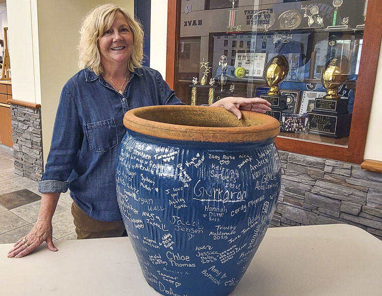 Beth Tugaw loves the gift that students at Hockinson High School gave her — a planter, signed by all. Tugaw will have plenty of time for gardening. She is retiring after 37 years in education. She has been at Hockinson High School since its opening in 2003. Photo by Paul Valencia