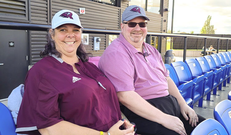 Carlene and Jerry Adamowicz, in their seats at the Ridgefield Outdoor Recreation Complex, say they love being a host family for the Ridgefield Raptors. Photo by Paul Valencia