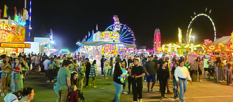 This photo was taken after 10 p.m. Sunday, after the Clark County Fair officially closed. There was no evidence that this party was going to end any time soon. The carnival stayed open late. Photo by Paul Valencia