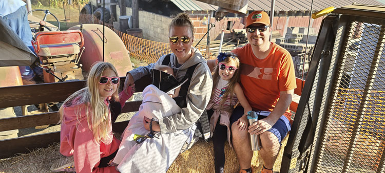 The Edwards family has been coming to Bi-Zi Farms for a decade now. Dave and Crystal love bringing their children Brooklyn, Haven, and baby Elliana on the hayride to the pumpkin patch. Photo by Paul Valencia