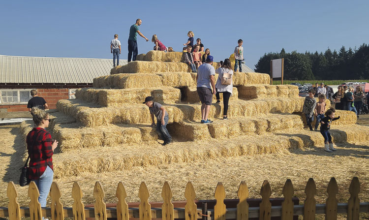 Climbers can try to conquer the bale pyramid, while other daring souls can try to solve the mystery of the corn maze at Bi-Zi Farms. Photo by Paul Valencia