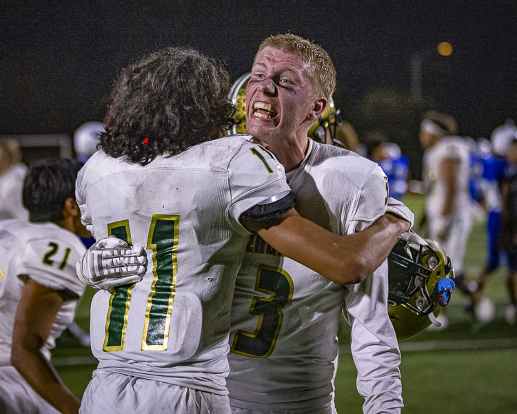 Jaxson Morris celebrates with Anthony Lamberth II (11) after Evergreen’s 20-14 victory over Mountain View on Friday night. Morris forced a fumble that Evergreen recovered with 23 seconds left, securing Evergreen’s victory. Photo by Mike Schultz