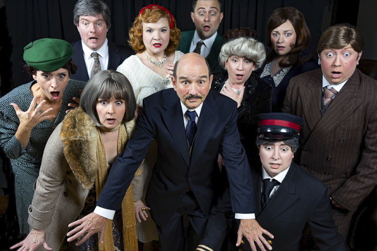 (Back Row, left to right) Michael Reid as Monsieur Bouc, Rob Wilson as Colonel Arbuthnot, Emily Smith as Mary Debenham. (Middle, left to right) Mindy Rees as Greta Ohlsson, Shaye Eller as Countess Andrenyi, Lynn Lavon as Princess Dragomiroff, Andrew Pongratz as Hector MacQueen. (Front, left to right) Kristen Noël as Helen Hubbard, Tony Provenzola as Hercule Poirot, and Charlie Duper as Michel the Conductor. Photo courtesy Fetching Photos