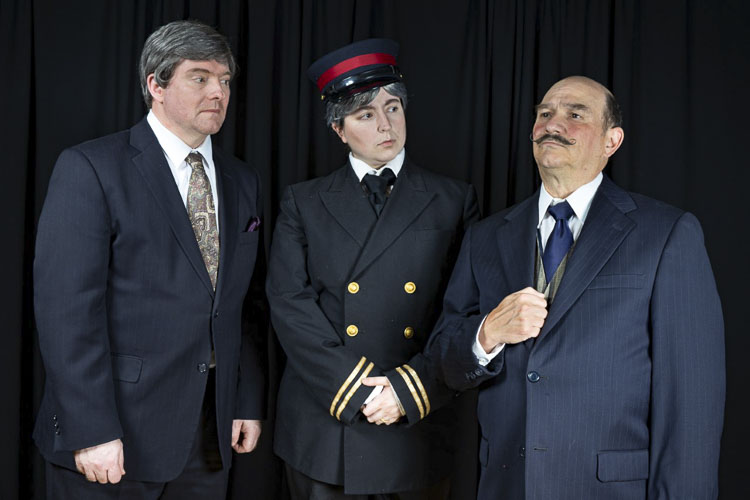 Monsieur Bouc (Michael Reid, left) and Michel the Conductor (Charlie Duper, middle) look on as Hercule Poirot (Tony Provenzola, right) ponders the mystery of the Orient Express. Photo courtesy Fetching Photos