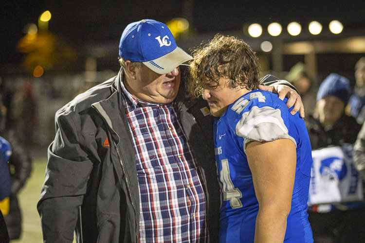 Clayton Muffett shares a moment with his father Win after La Center’s loss in the Class 1A state football playoffs. Photo by Mike Schultz