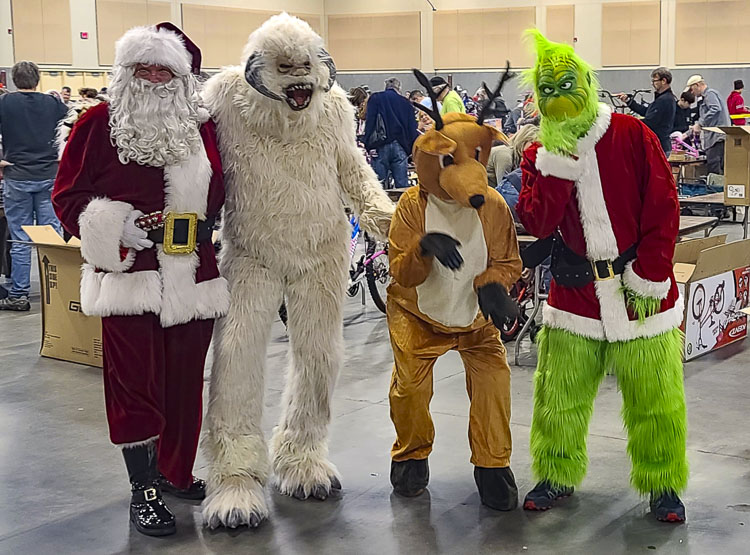 An interesting collection of “friends” showed up at the Bike Build on Saturday. It’s Santa Claus, a Wampa, a reindeer, and The Grinch. Photo by Paul Valencia