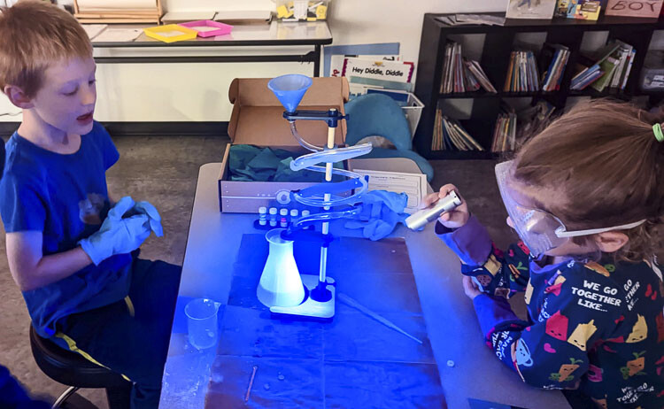 K-3 students (left to right) Ammon Caine and Ele Kuhn perform an experiment with Glow Lab at Wisdom Ridge Academy. Photo courtesy Ridgefield School District