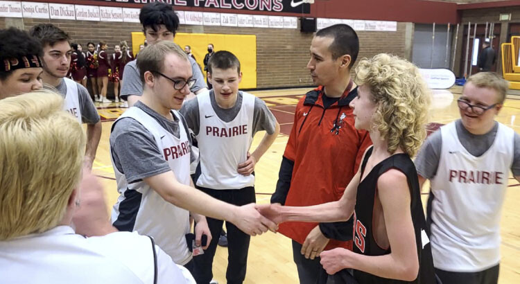 Nick Fox, left, of Prairie and David Huyette of Camas shake hands after their teams played in a Unified Sports basketball tournament on Saturday. Huyette was presenting Fox with a sportsmanship pin. Photo by Paul Valencia
