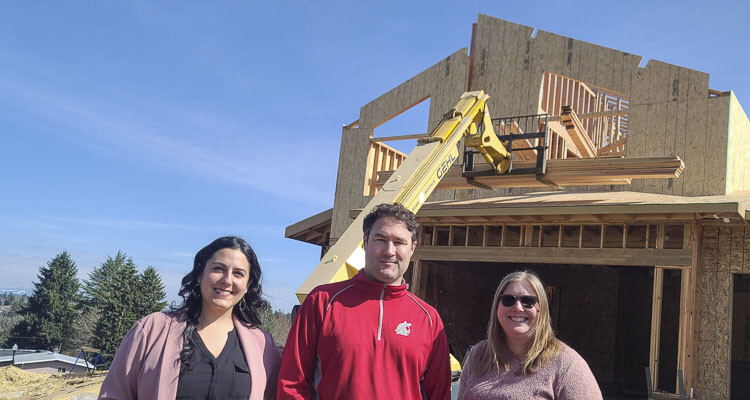 Alexa Lee of GRO, Bart Hansen, the executive director of the Building Industry Association of Clark County, and Danielle Kilian, the events director for the BIA, stand in front of construction at what will become the 2023 GRO Parade of Homes. Photo by Paul Valencia