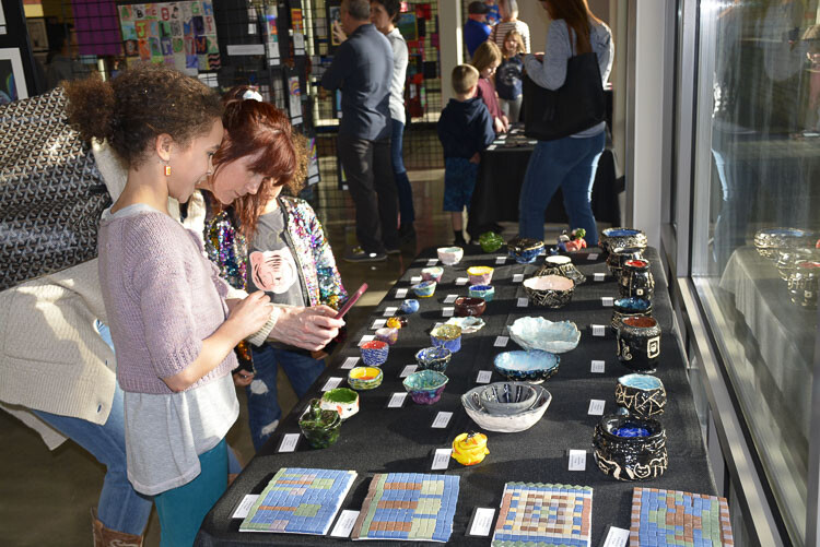 Families visit the Washougal Youth Arts Month Gallery to view ceramics made by local students. Photo courtesy Washougal School District