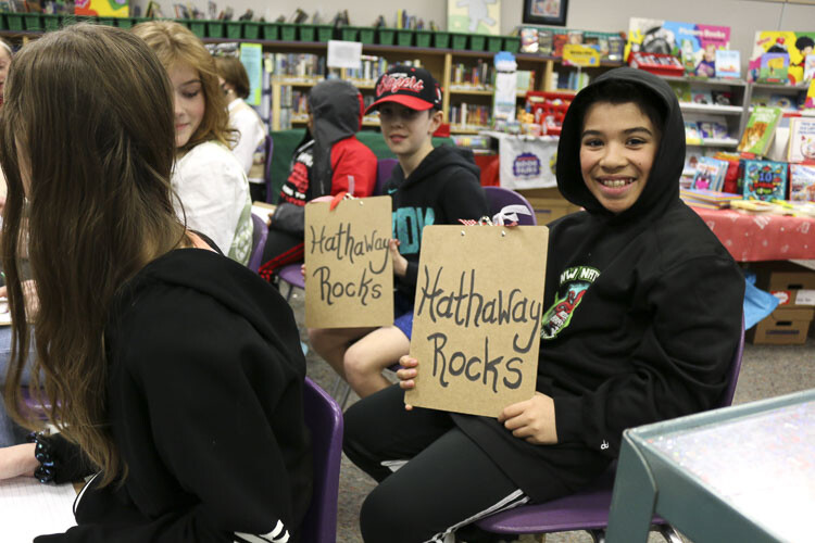 Parker Paul and Jace Seto, 5th grade student leaders at Hathaway Elementary School, show school pride in the library during the AASA school site tour. Photo courtesy Washougal School District