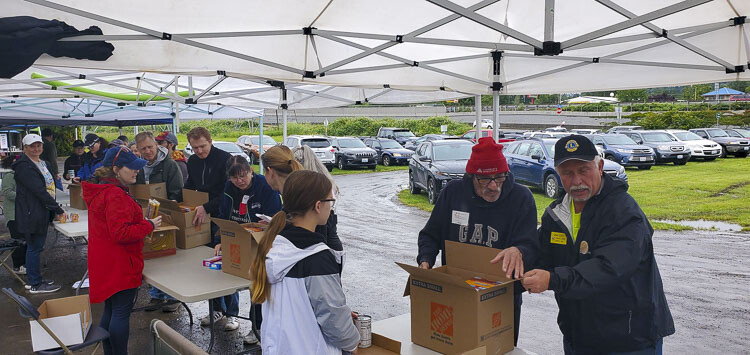 Volunteers, organized by St. Matthew Lutheran Church in Washougal, will be filling food boxes, and collecting donations to assist local families. Photo courtesy Impact CW