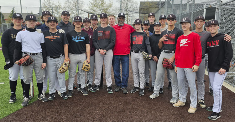 Lee Hunter, surrounded by his players, is the Union High School baseball coach. He persevered for decades, and overcame serious health issues, to land the job, calling his journey a dream come true. Photo by Paul Valencia