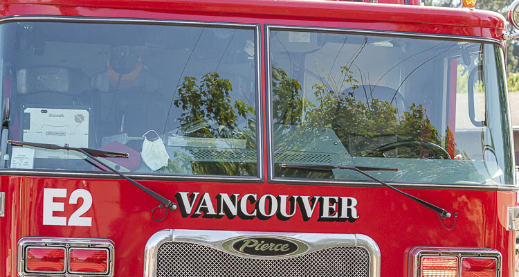 Vancouver Fire Department swiftly extinguishes garage fire in East Vancouver, preventing it from spreading to the house; five adults and a dog displaced, cause under investigation.