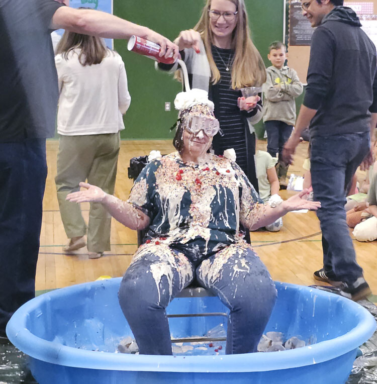 Jacqui Vansoest, the principal of Green Mountain School, allowed students and staff to turn her into an ice cream sundae on Wednesday, after students raised more than $10,000 for the PTSO. Photo by Paul Valencia