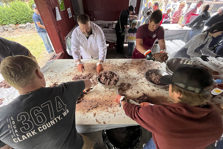 The pulled pork is prepared for the sandwiches at the Planters Days Fireman’s BBQ Saturday. Photo by Mike Schultz