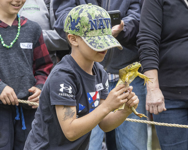 Maverick Ripp struggles to hold on to this frog during Saturday’s Planters Days Frog Jumping Contest. Photo by Mike Schultz