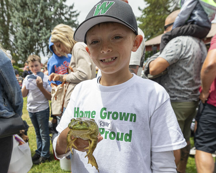 River Sloan shows off the frog he captured at the Planters Days Frog Jumping Contest. Photo by Mike Schultz