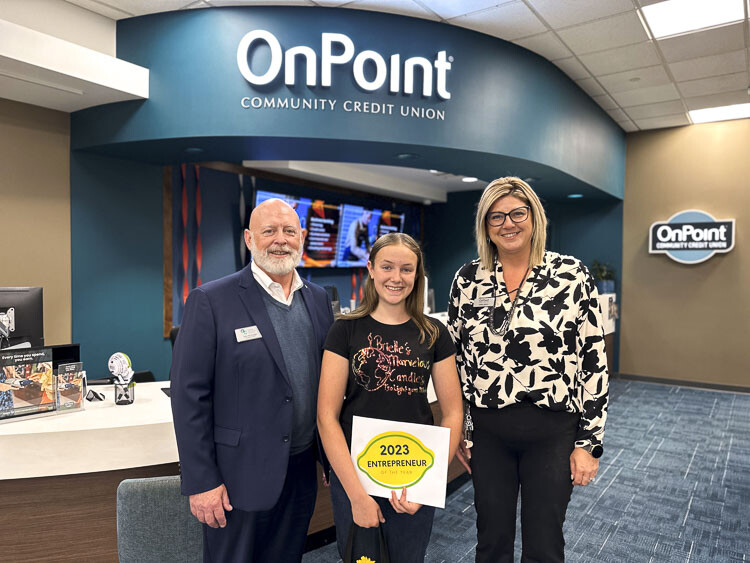 To honor Brielle Stuart's exceptional achievements, she received a well-deserved prize package, presented by GVC President & CEO John McDonagh and OnPoint Salmon Creek Branch Manager JaNae Ogden. Photo courtesy Greater Vancouver Chamber