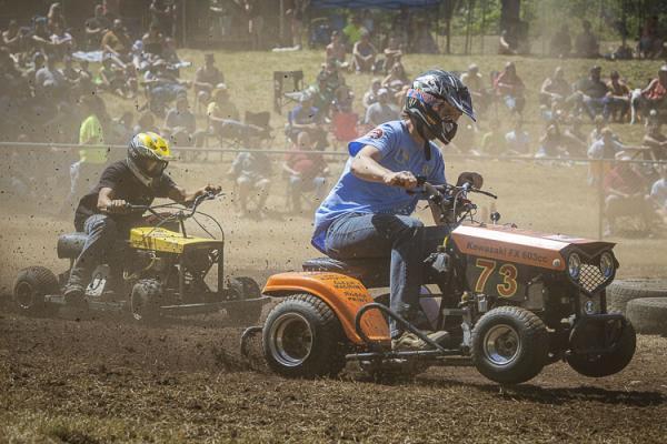 Chad Kuschel hits the gas to try to catch Roland Barker during the Lawn Mower Races Sunday. Photo by Mike Schultz