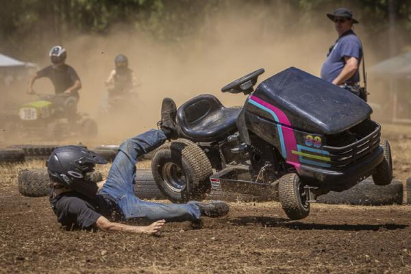 Wyatt Peterson had a little trouble staying on his lawn mower during Sunday’s event. Photo by Mike Schultz