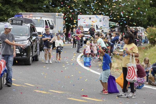 Children loved the confetti and candy offered in Saturday’s parade. Photo by Mike Schultz