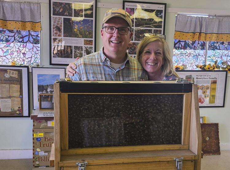 Dean and Jen Mathews are two of the volunteers who work at the Bee Barn at the Clark County Fair, answering questions about bees. Photo by Paul Valencia