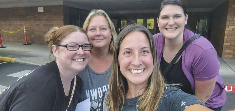 Four moms — (left to right) Christina Chappell, Angie Waudby, Brittney Allen, and Samantha Rupp — representing the Evergreen Plainsmen Foundation have taken over management of the Clark County Youth Football Food Drive. Photo courtesy Brittney Allen