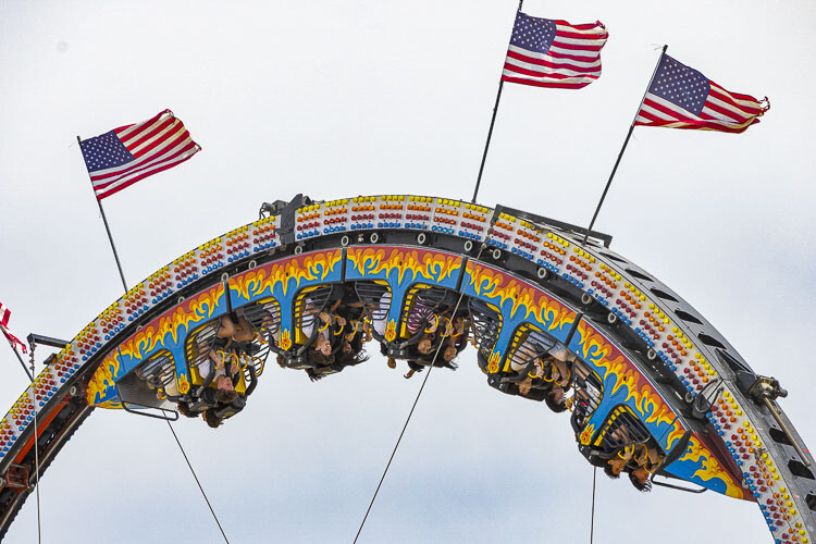 Everything is upside down, which means all is right in the world at the Clark County Fair. The carnival was packed with riders as soon as the carnival opened Friday. Photo by Mike Schultz