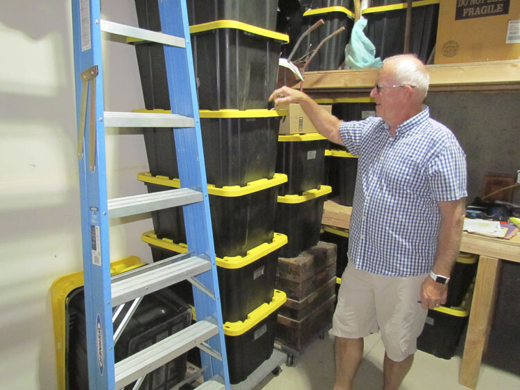 Dean Sutherland examines tubs in a storage unit provided with his condo at The Sahalie at Tidewater Cove. Photo courtesy Marvin Case