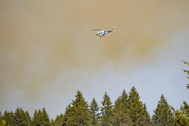 Helicopter operations battling the Jenny Creek Fire are viewed here from NW 359th St. and NW 14th Ave. Photo by Mike Schultz
