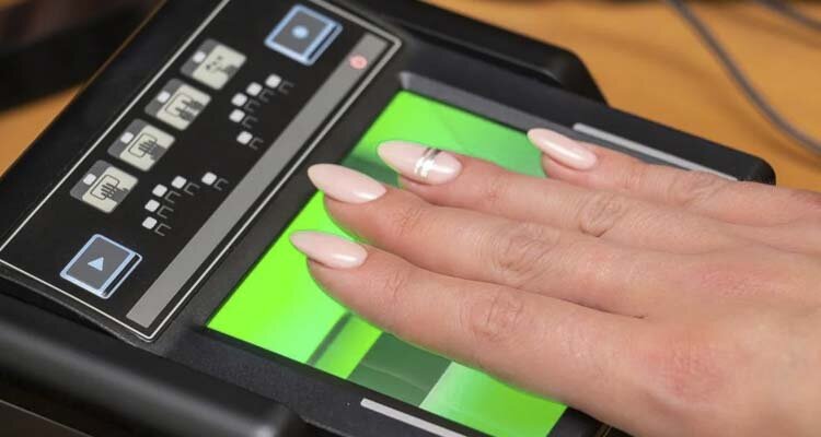 The process of scanning fingerprints during the check at border crossing. Photo courtesy Ivan Semenovych/Shutterstock