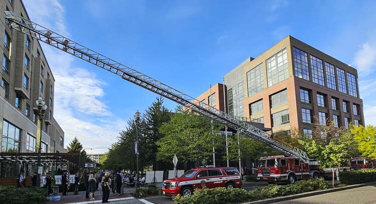 A fire truck, with its ladder extended, is parked in front of City Hall on Monday, part of a ceremony to remember Sept. 11, 2001. Photo by Paul Valencia
