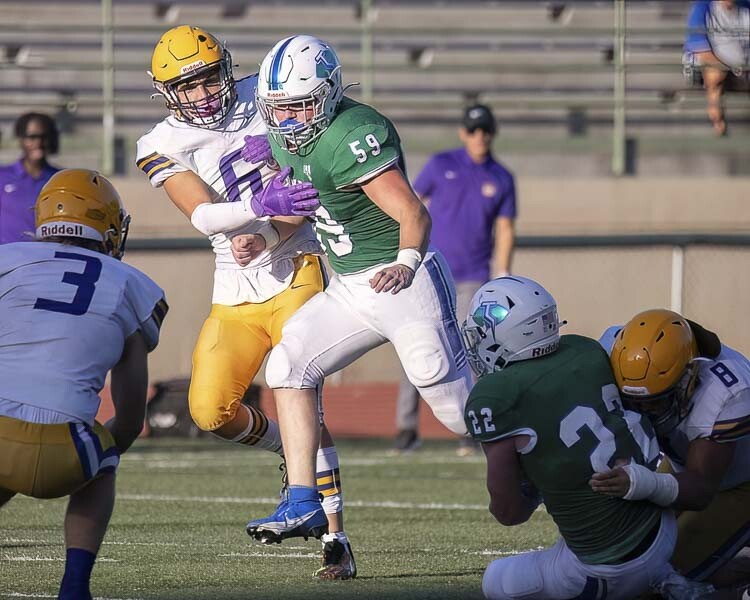 Mountain View senior Joseph Burcham (59) is always looking to move downfield, searching for another block or be in position to make a play, even after he takes care of his initial blocking duties at the line of scrimmage. Photo by Mike Schultz